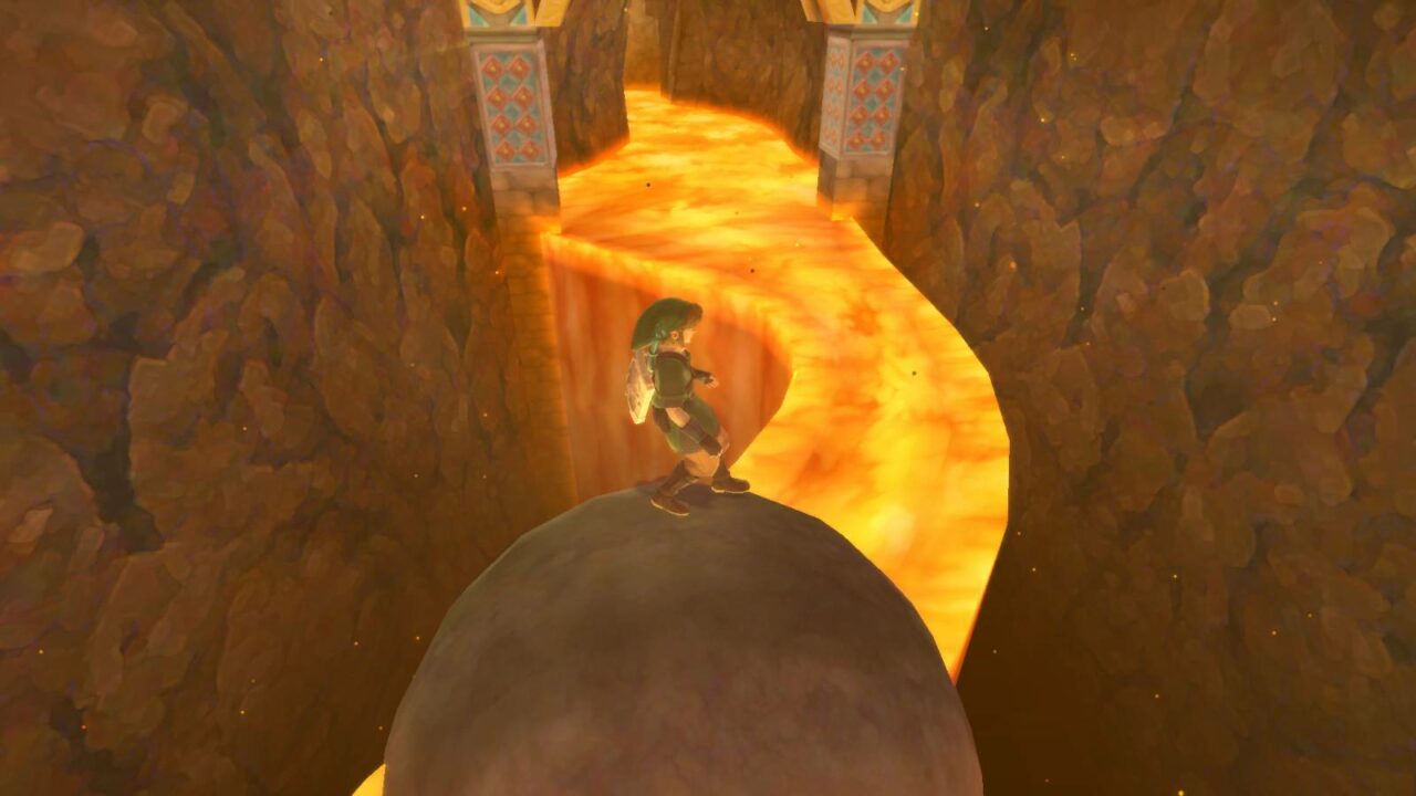 Link balanciert auf einem Felsbrocken. Vor ihm ist ein Fluss aus Lava, der links und rechts von ihm ins Nichts stürzt.
