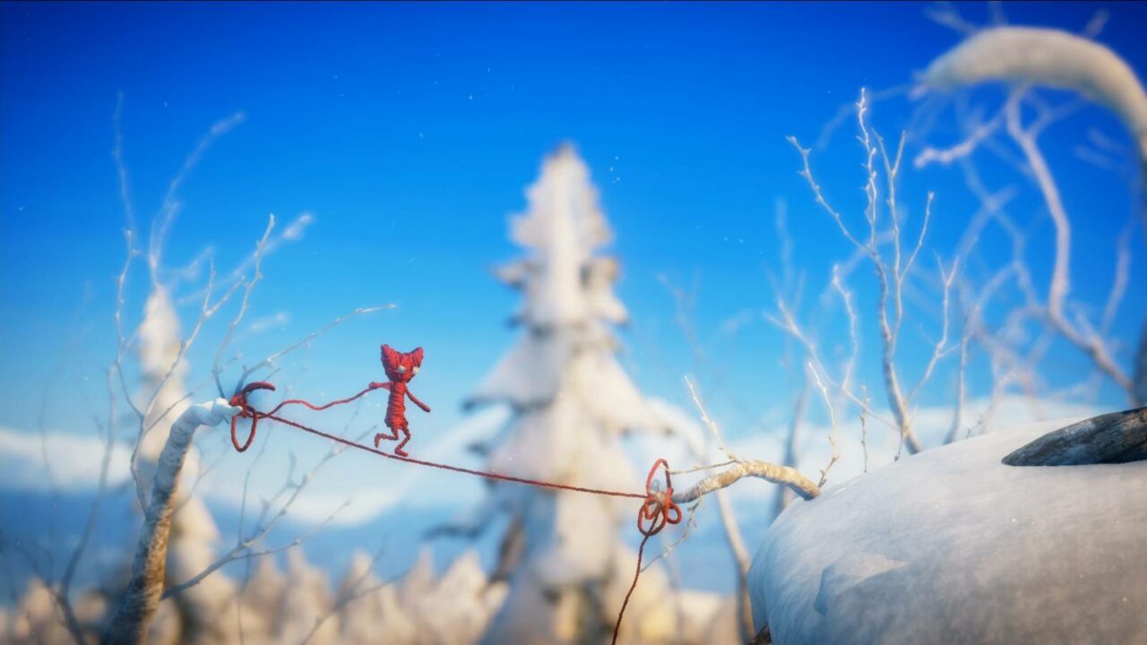 Yarny hat seinen Faden zwischen zwei verschneiten Ästen gespannt und läuft hinüber.