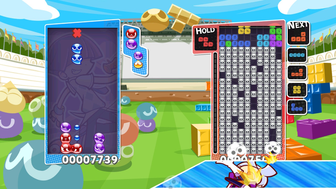 Zwei Spielbretter: Einer spielt mit bunten Kreisen (Puyos), auf dem andere wird Tetris gespielt.