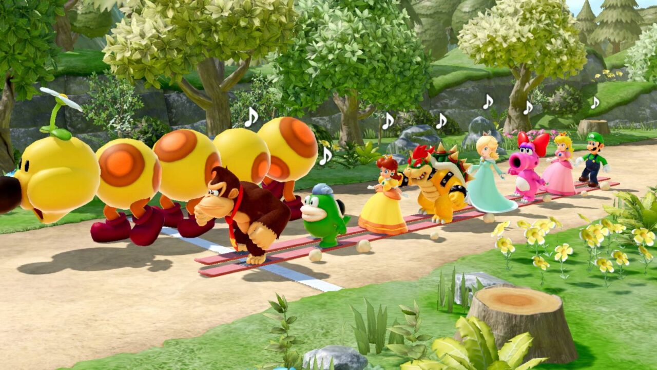 Eine Reihe von Mario-Charakteren im Trockenski-Rennen gegen die Raupe Wiggler.